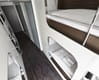 Bunk beds that are divided into cabines with bath and toilet in the same room